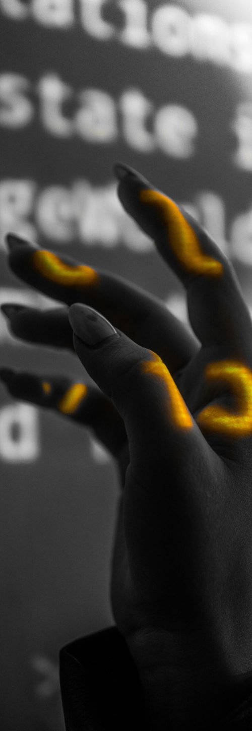 pexels-photo-8597325-8597325 A striking black and white hand with glowing digital overlays capturing modern technology and art.